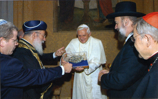 Benedict receiving a gift from several rabbis
